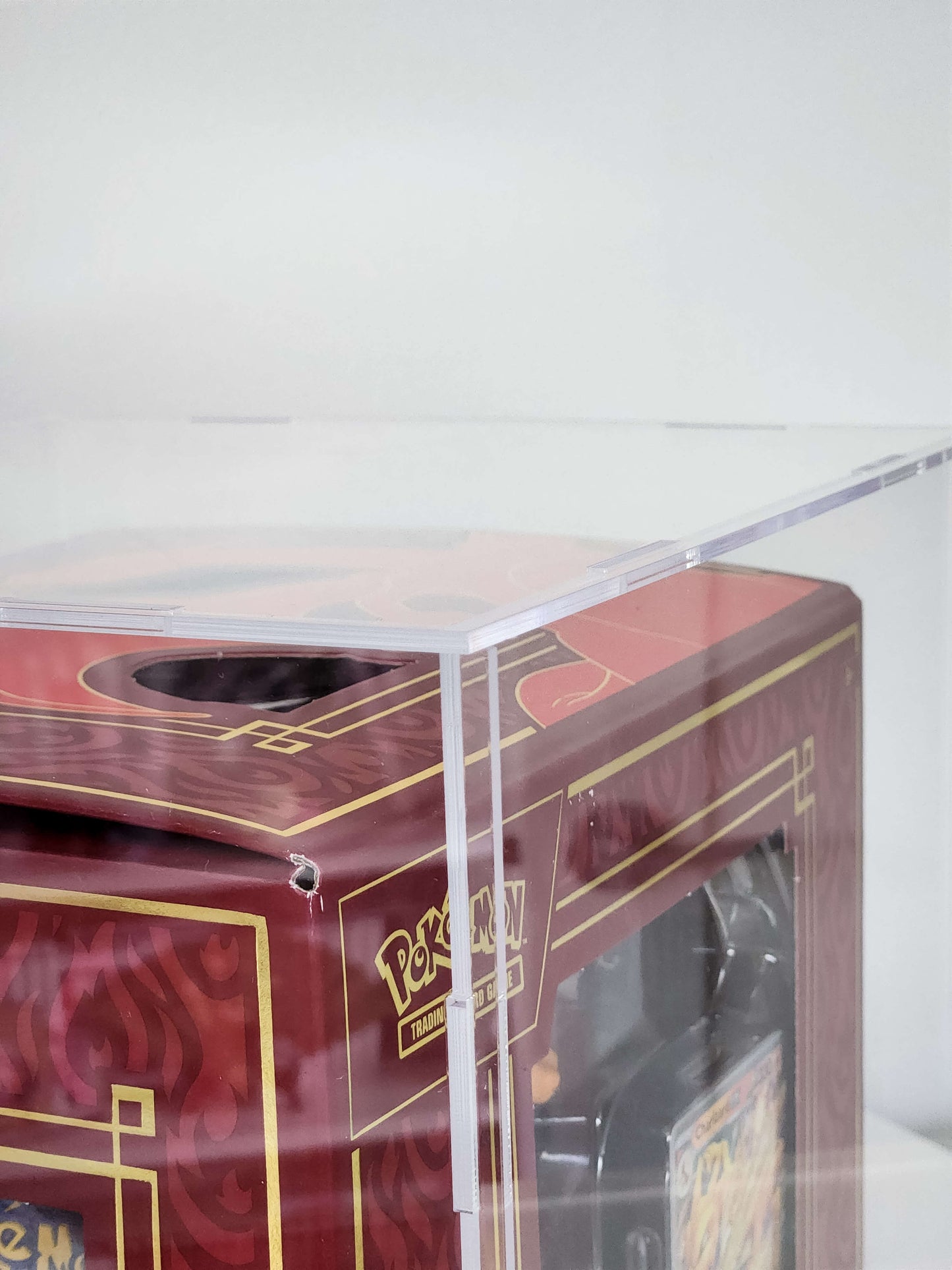 Red and gold collectible card display case with 'Pokémon' branding on a white background