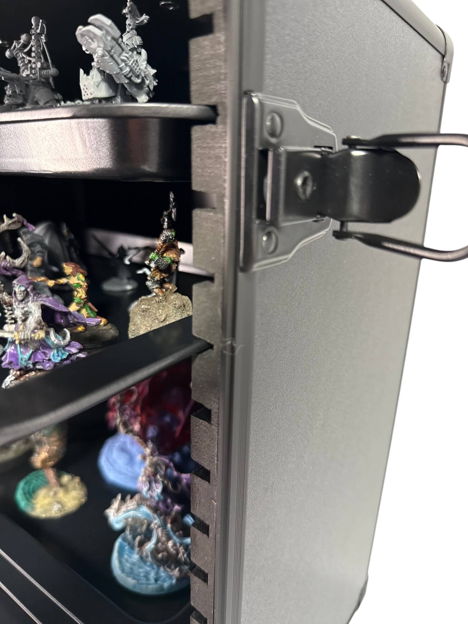 Metallic display case with small figurines on a white background