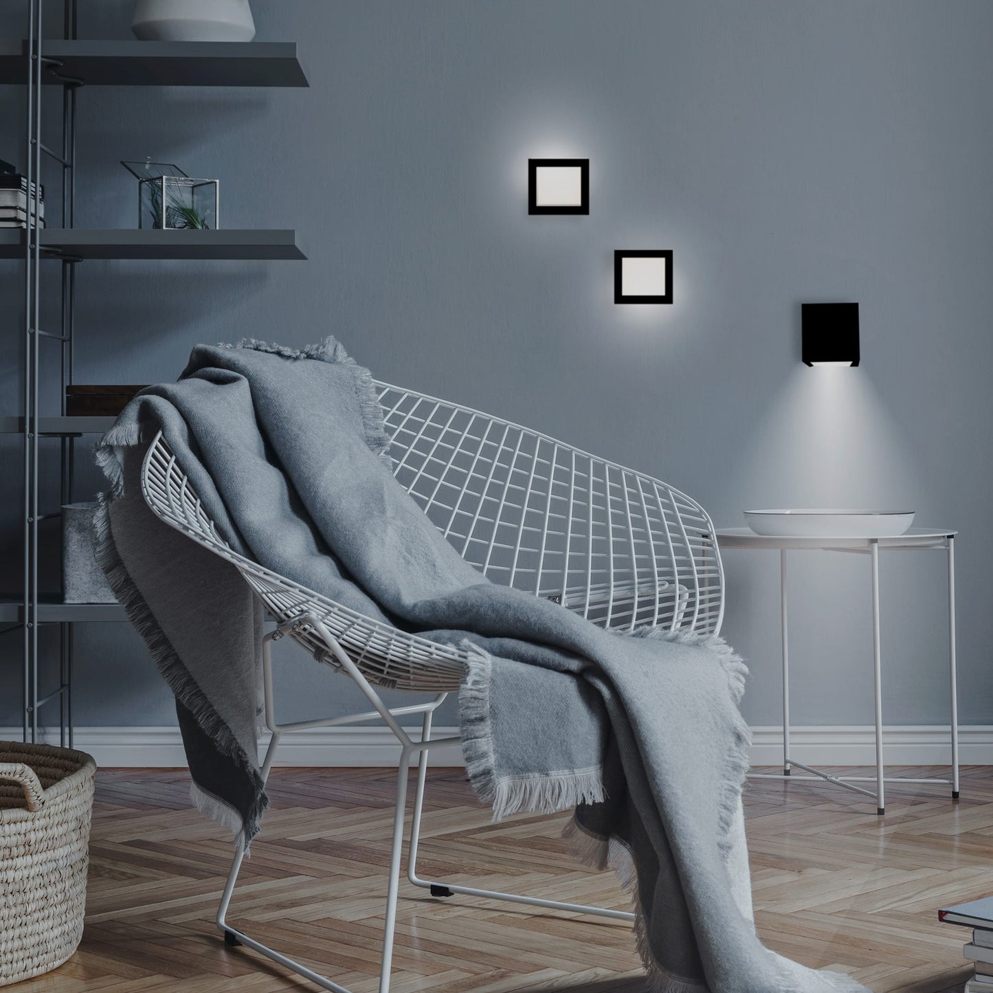 Modern living room with a wire chair, gray blanket, and wall lights.