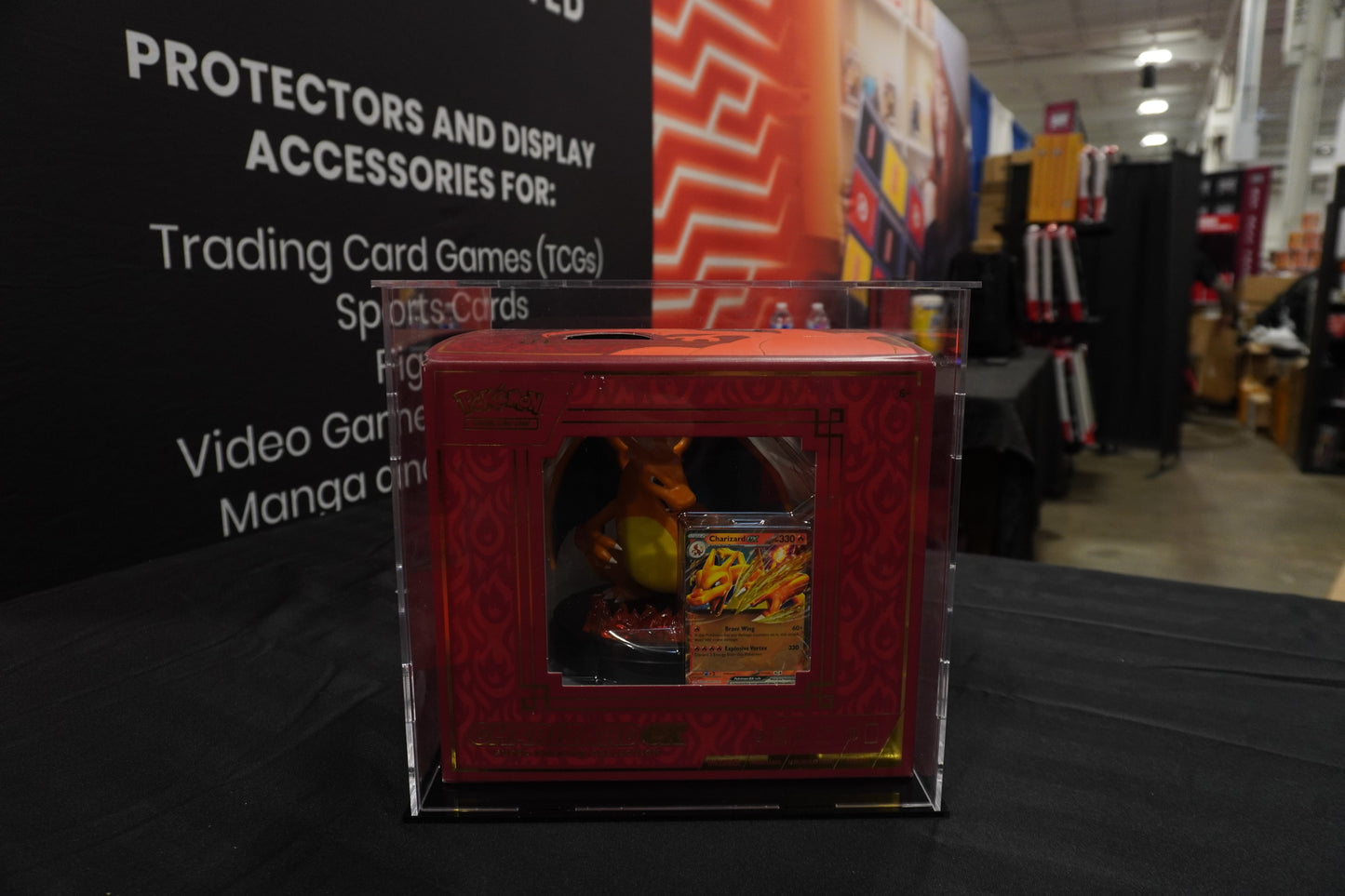 Red trading card game booster box on a table with a blurred store background