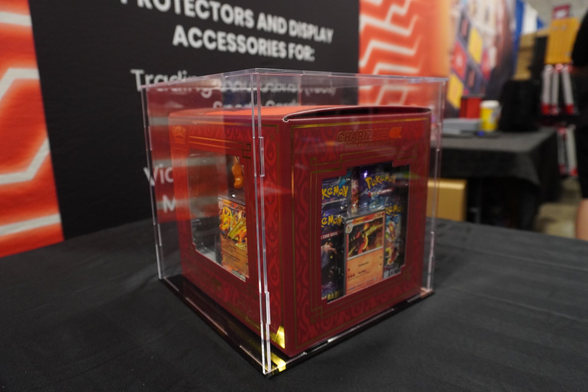 Trading card game box with transparent lid on a table