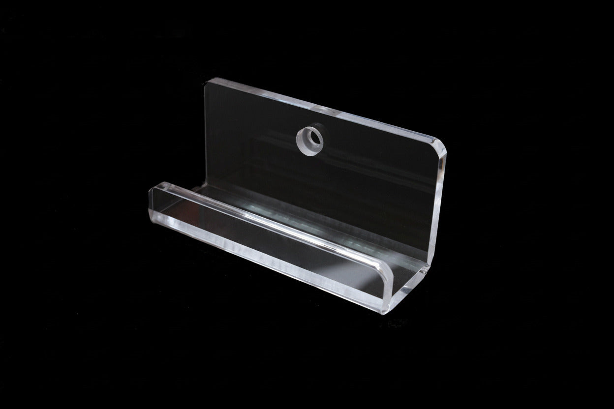 Clear acrylic sign holder on a black background