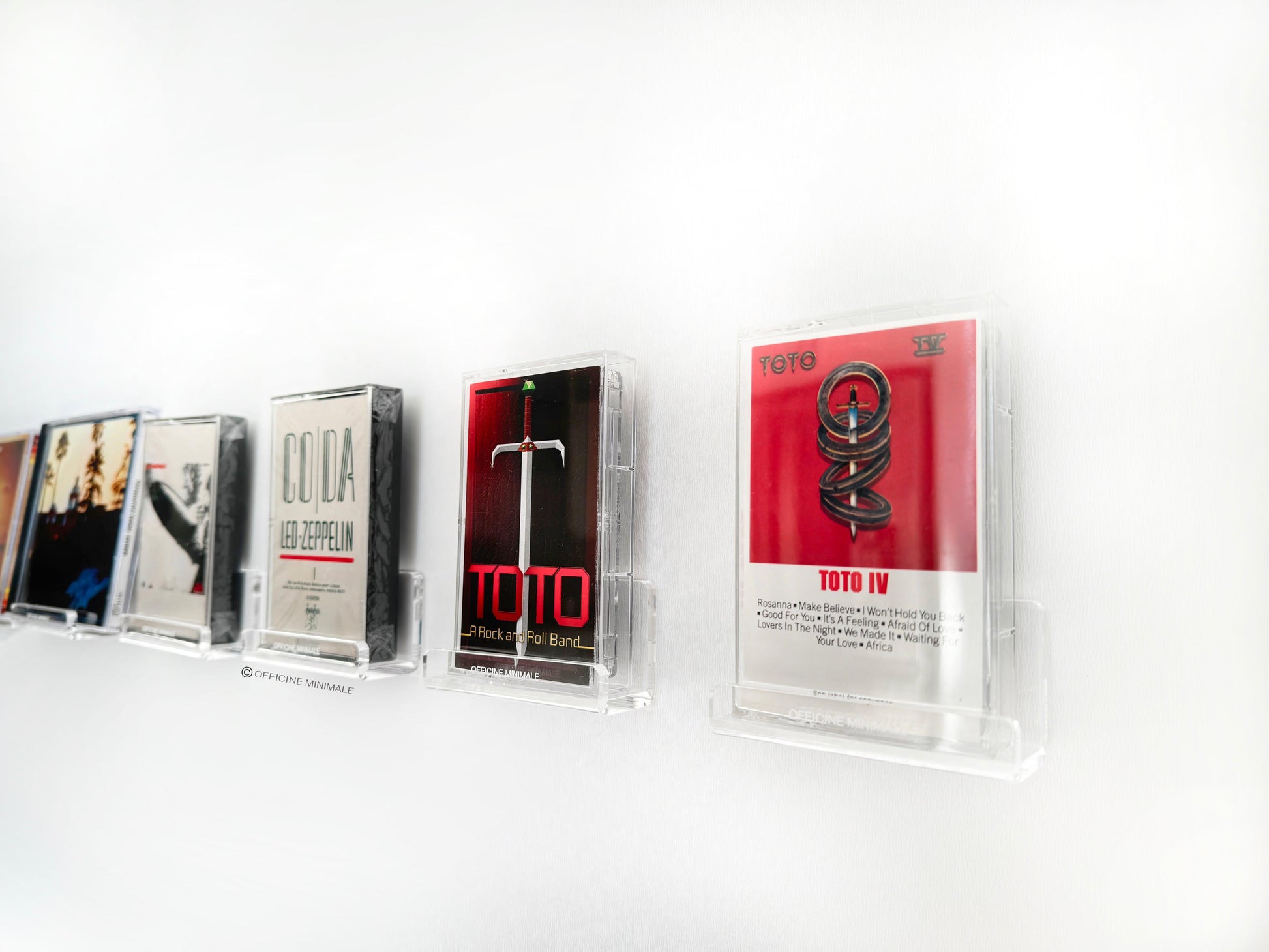 Collection of vintage cassette tapes on a white shelf